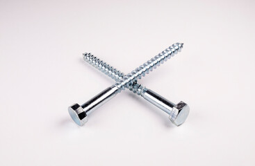 screws on a white background. Cross made of screws. Hex head screw on white background