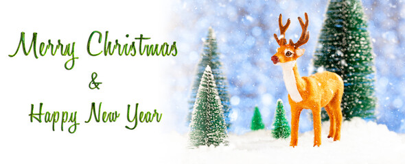 Merry Christmas card, toy deer in a snowy forest, concept