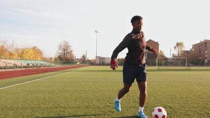 Close-up of a legs of a black soccer player practicing ball possession in a training session. Football dribbling - Powered by Adobe