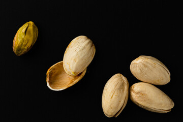 top view of pistachio nuts on black background