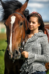 Obraz premium teenager girl with a horse in the field