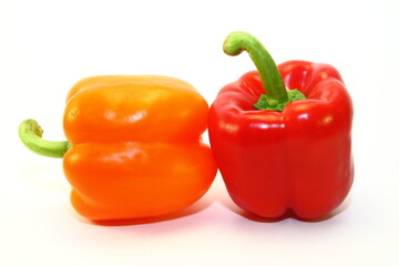 red and  orange peppers on white background