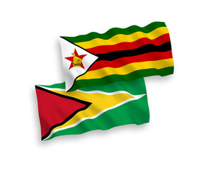 Flags of Co-operative Republic of Guyana and Zimbabwe on a white background