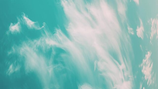 Vertical Shot Light Cirrus Clouds Cloud Sky In Blue Aquamarine pale-blue colors Moving In Sky. Natural Background Cloudscape 4K Time Lapse, Timelapse, Time-lapse. 4K Blue Background. Abstract Blue