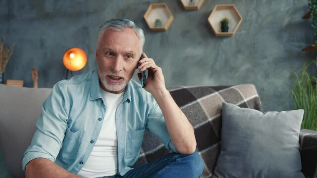 Positive grandpa use device tell say family news sit divan in apartment