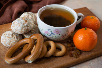 a cup of green tea with gingerbread and tangerines