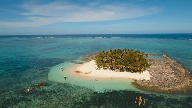 aerial footage tropical island with beach and palm trees lagoon with turquoise water Sea tropical landscape Guyam island, Philippines, Siargao. Travel concept Aerial video