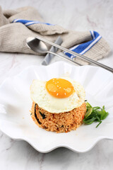 Bokkeumbap or Kimchi Fried Rice, South Korea Traditional Recipe Fried Rice with Kimchi, Spring Onion, Sesame Seed, Tomato, and Nori (Laver). Served on WHite Ceramic Plate