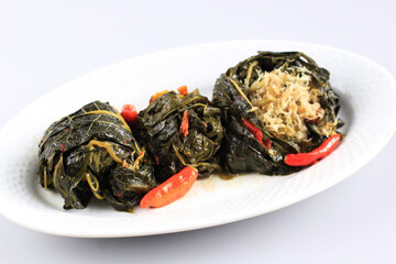 Buntil is Traditional Indonesian Food Made from Papaya/Cassava Leaves Stuffed with Grated Coconut, Petai Cina,  and Anchovy Fish. Popular in Javanese and Sundanese Cuisine, Copy Space Isolated