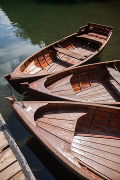 Three wooden boats on a lake