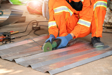 Construction worker cut the roofing sheet