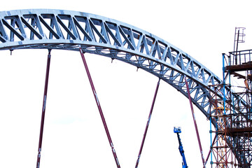 The construction of the bridge. Fragment of a large, metal arch. High-tech, engineering construction.