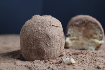 chocolate cake potatoes with coffee cappuccino on cocoa on a black background. Chocolate coffee dessert