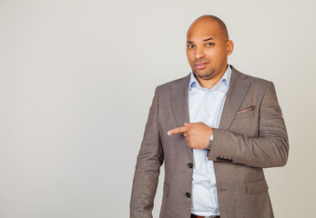 African man male discontent, expresses disgust and dislike points index finger to the side on copy space, disappointed with bad product with disgust. Copy space.