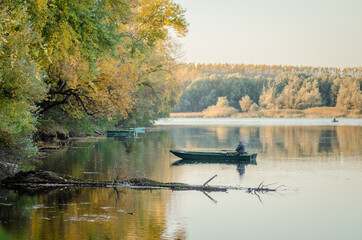 Fototapeta premium Begec, Serbia - October 30. 2021: Sport fisherman in a boat on an artificial lake near Novi Sad.