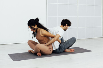 Man and woman together doing exercises family yoga asana fitness