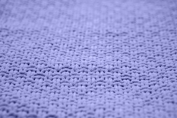 Color of the year 2022 very peri. Knitted sweater texture closeup. Trendy soft abstract background.