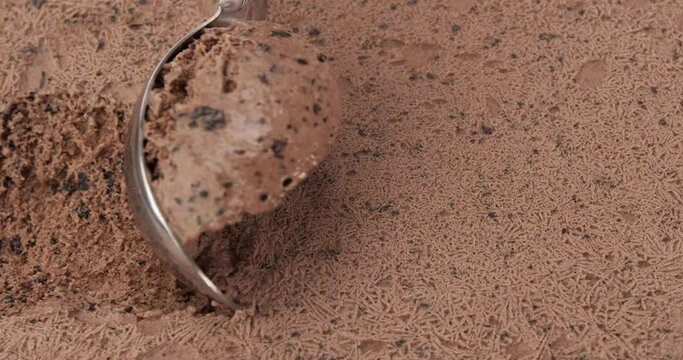 Close up, Slomotion Chocolate Chip Icecream Rolls. And traces of being scooped by a spoon.