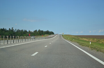 A wide four-lane road with a separator. Federal highway in Russia. Road markings. Road safety.