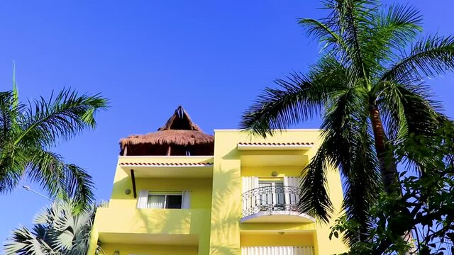 Typical yellow residence hotel condominium building Playa del Carmen Mexico.