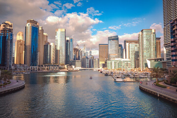 Fototapeta na wymiar Beautiful view of the waterway that passes through the middle of the Dubai Marina district, surrounded by tall skyscrapers, Dubai, UAE