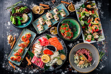 Assorted Chinese food set. Chinese noodles, dim sum, Famous Chinese cuisine dishes on black table. Top view. Chinese restaurant concept. Asian style