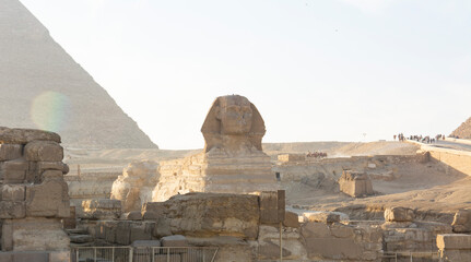 Fototapeta na wymiar Egyptian Sphinx against the background of the ancient pyramids in Giza