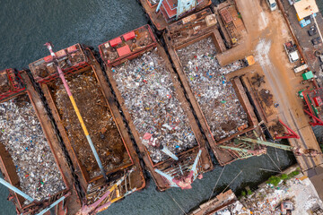 Recycling scrap metal plant over crane load a cargo ship vessel