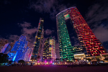 Scenic night view of the skyline of the Dubai Marina district with it's tall skyscrapers raising next to the beach and the waterfront, Dubai, UAE