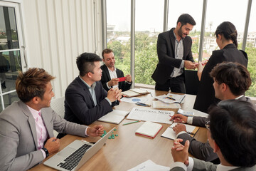 boss or manager or leader congratulations staff or employee successes in work and giving money bonus to business teamwork group