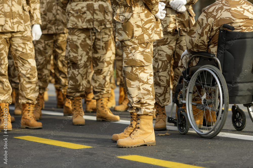 Wall mural romanian army veteran soldiers, of which one is injured and disabled, sitting in a wheelchair, prepa