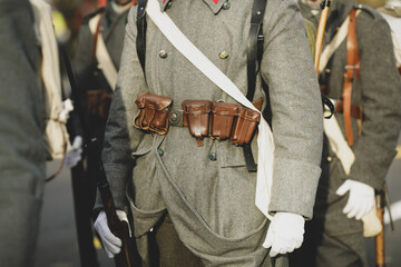 Details with the uniforms and weapons of World War I reenactors.