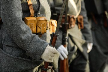 Details with the uniforms and weapons of World War I reenactors.