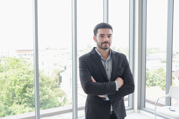 Fototapeta premium caucasian businessman standing in office room near window