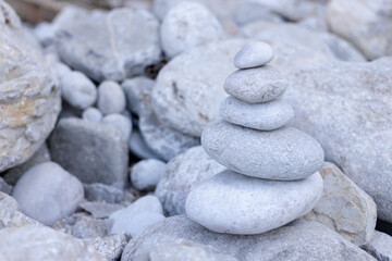 Fototapeta na wymiar Stack balancing pebble stones pool with out of focus for background