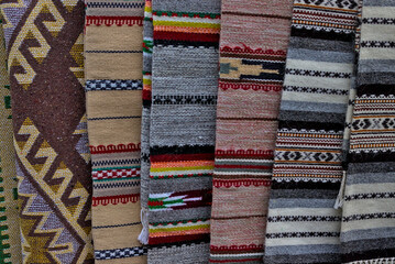 Yablunytsya pass, Ivano-Frankivsk oblast, Ukraine -  Open Air Traditional Crafts Fair. Traditional Ukrainian patterns and designs made on woven products. Embroidery on the carpet.