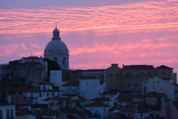 Cityscape Image of Lisbon, Portugal during dramatic sunrise.