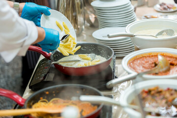 Cooking spaghetti concept. Pasta in the pan. Cooking Fresco Pasta. Italian cuisine, Cooked Italian spaghetti being put into hot bolognese sauce in the pan