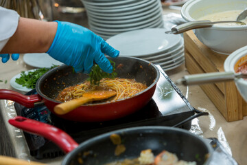 Cooking spaghetti concept. Pasta in the pan. Cooking Fresco Pasta. Italian cuisine, Cooked Italian spaghetti being put into hot bolognese sauce in the pan