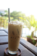 ice coffee on wooden table closeup