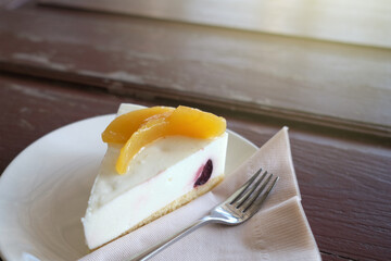 Fototapeta premium A slice of yogurt cake closeup on wooden table