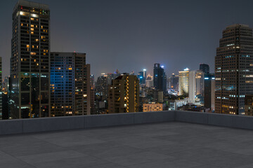 Panoramic Bangkok skyline view, concrete observatory deck on rooftop, night time. Asian corporate...