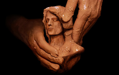 Hands of God creating man from clay. Religious conceptual theme.