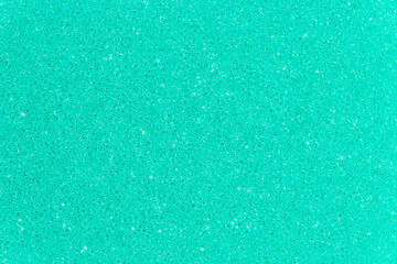 Turquoise color foam sponge porous texture background. Extreme close-up view of detail abstract synthetic material. Horizontal composition.