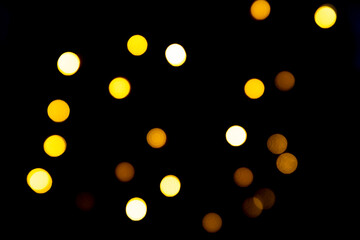 Christmas or New Year yellow blurred textured bokeh lights background