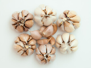 Peeled whole garlic in cloves isolated on white background with negative space