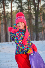 In winter, there is a little  girl in the forest.