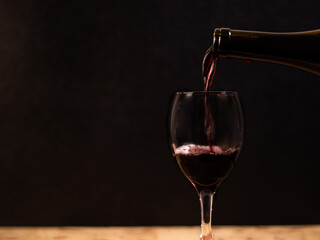 The wine is born from the grape, photography on black background and wooden table