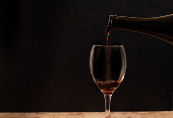 The wine is born from the grape, photography on black background and wooden table