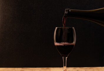 The wine is born from the grape, photography on black background and wooden table